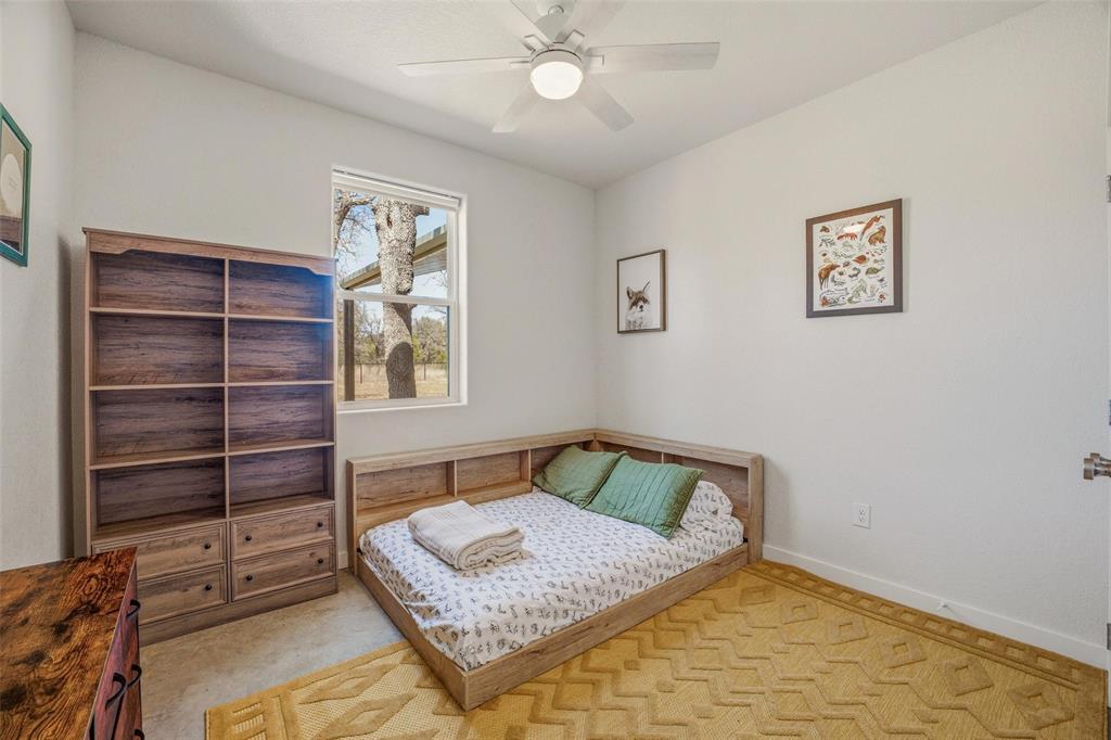 1525 North Bosley Road Santo, TX 76472 - Photo 27 of 40 a bedroom with a bed and a window