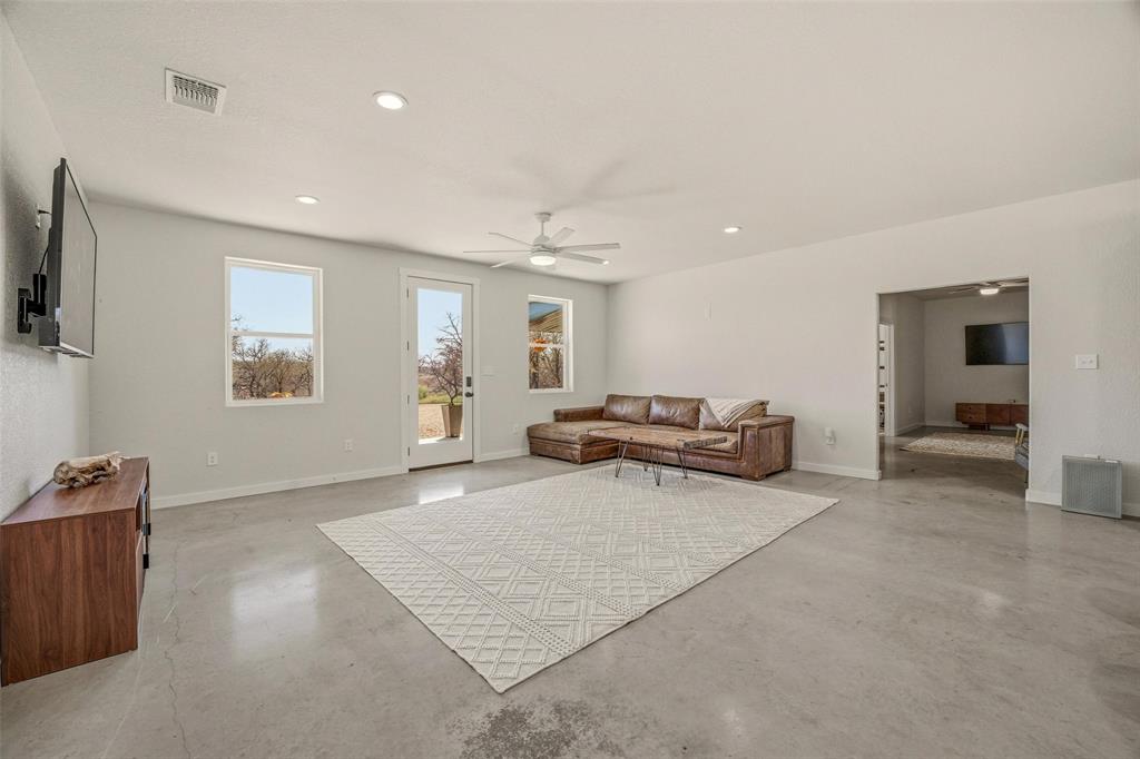 1525 North Bosley Road Santo, TX 76472 - Photo 8 of 40 a living room with furniture and a flat screen tv