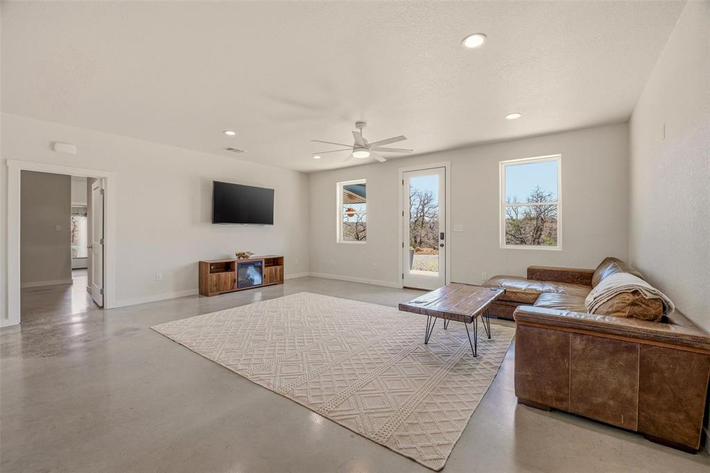 1525 North Bosley Road Santo, TX 76472 - Photo 10 of 40 a living room with furniture and a flat screen tv