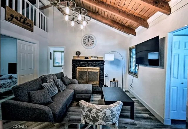 a living room with furniture a flat screen tv and kitchen view