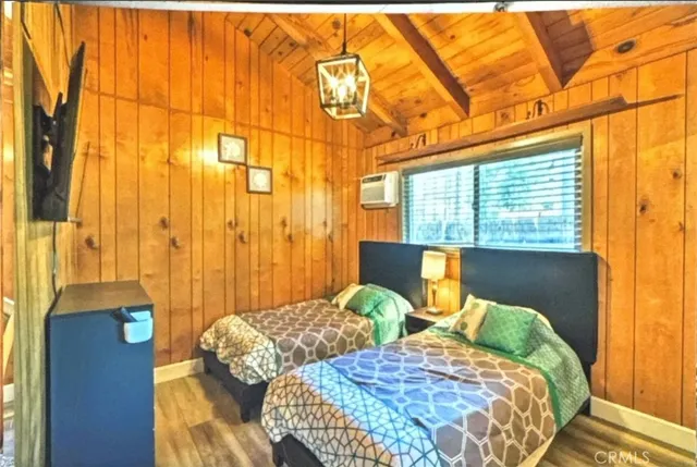 a bedroom with two beds and a large window