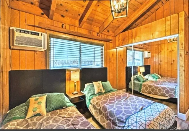 a bedroom with two beds and a window