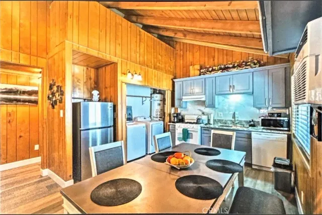 a kitchen with stainless steel appliances a stove a refrigerator and a stove