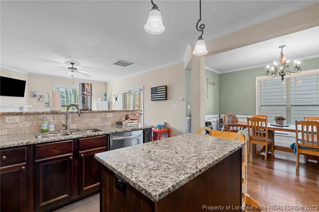 1365 Micahs Way North Spring Lake, NC 28390 - Photo 11 of 36 a kitchen with center island table and chairs