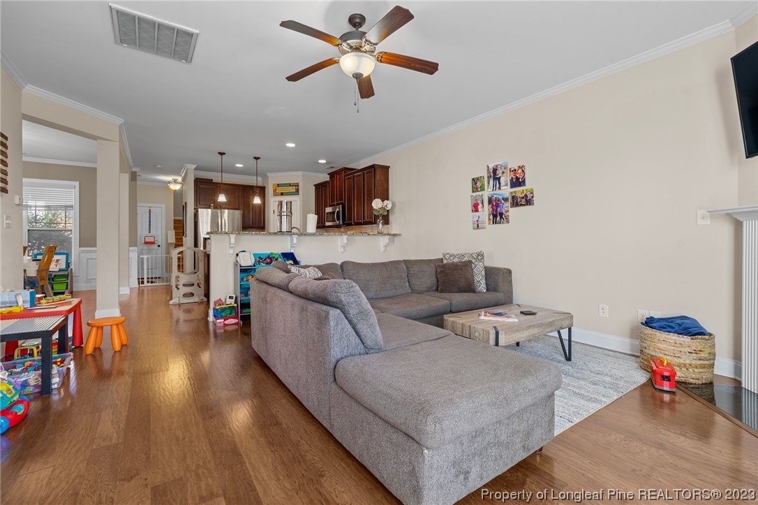 1365 Micahs Way North Spring Lake, NC 28390 - Photo 15 of 36 a living room with furniture and kitchen view