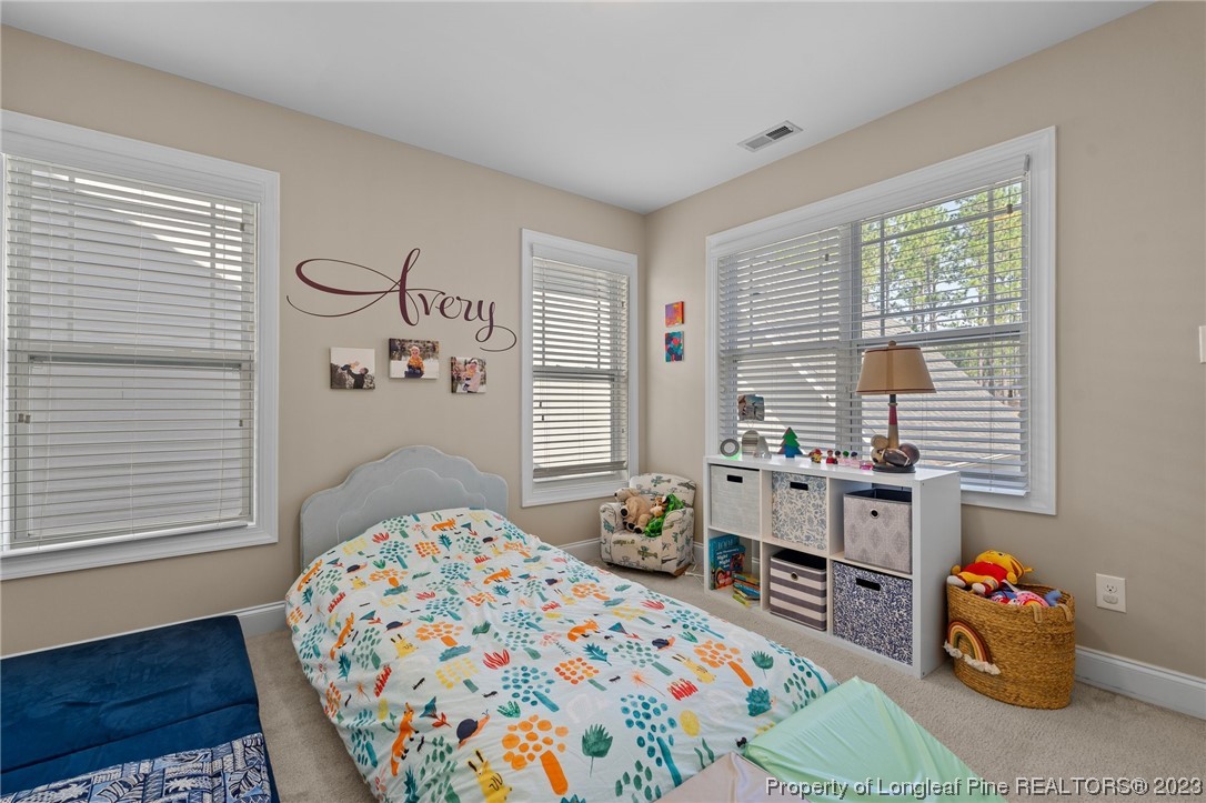1365 Micahs Way North Spring Lake, NC 28390 - Photo 20 of 36 a bedroom with a bed and a window