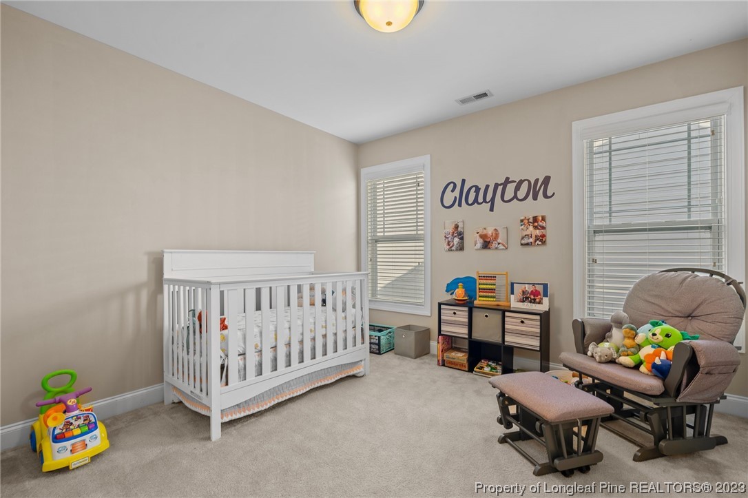 1365 Micahs Way North Spring Lake, NC 28390 - Photo 21 of 36 a bedroom with furniture and a chair