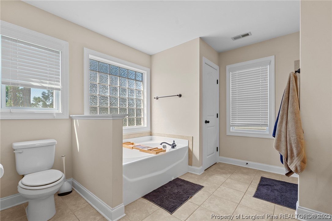 1365 Micahs Way North Spring Lake, NC 28390 - Photo 22 of 36 a bathroom with a sink a toilet and shower