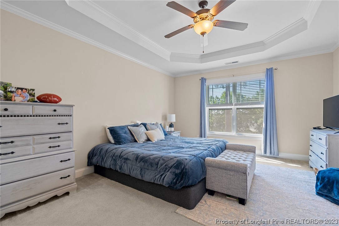 1365 Micahs Way North Spring Lake, NC 28390 - Photo 24 of 36 a bedroom with a bed and a chandelier