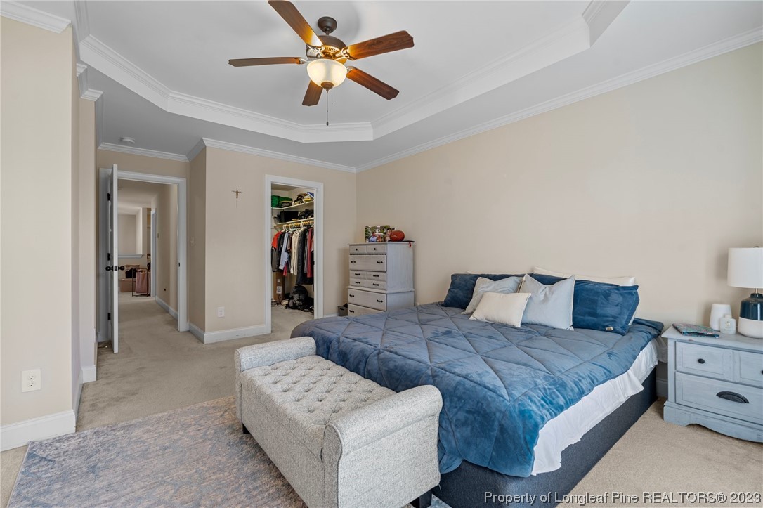 1365 Micahs Way North Spring Lake, NC 28390 - Photo 26 of 36 a bedroom with a large bed and a chandelier