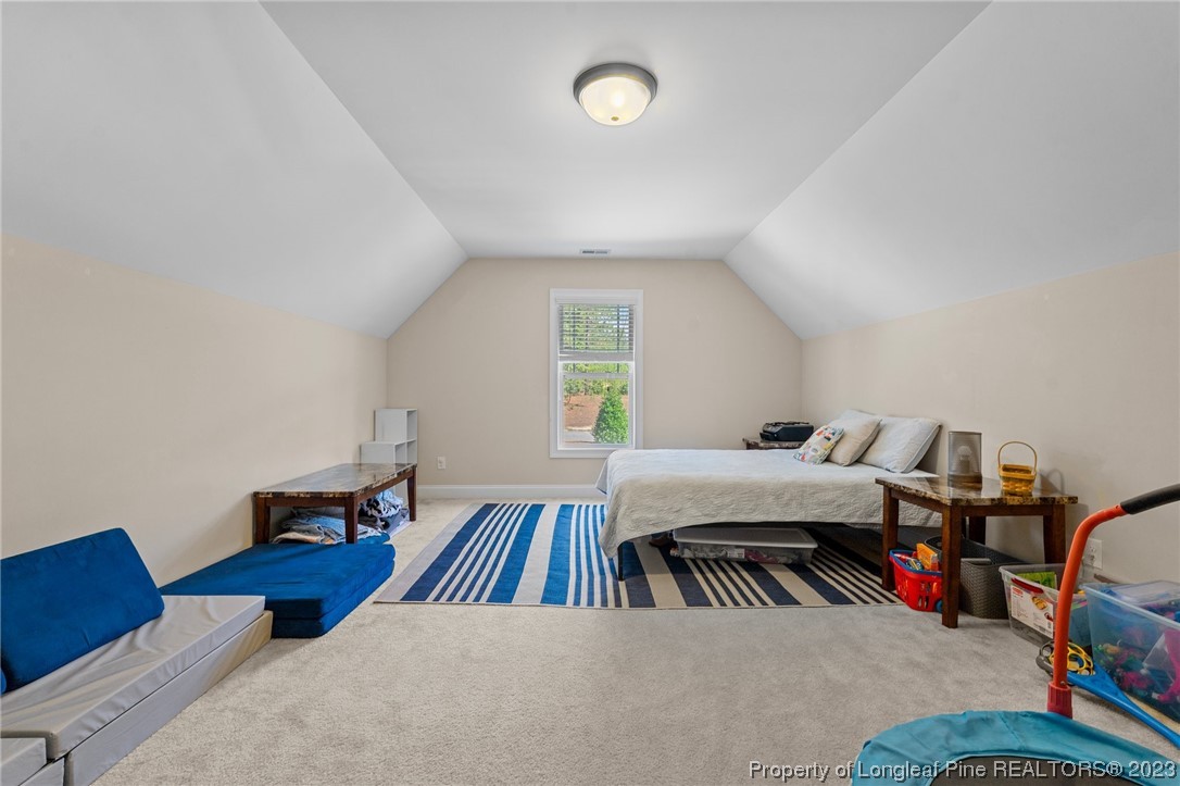 1365 Micahs Way North Spring Lake, NC 28390 - Photo 31 of 36 a bedroom with furniture and a wooden floor