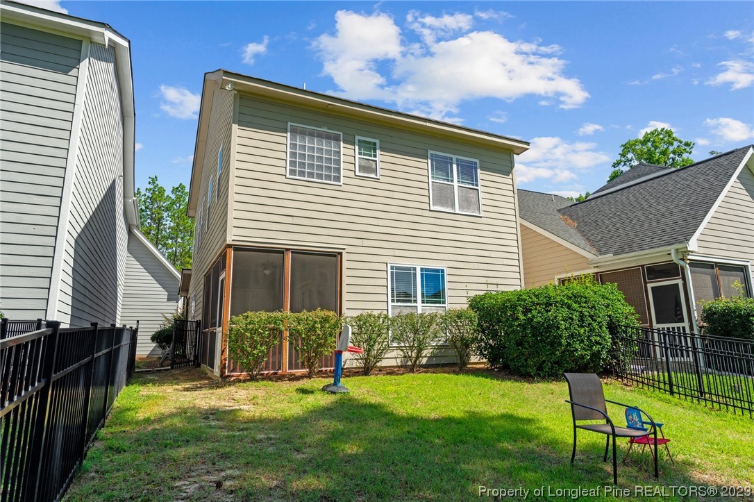 1365 Micahs Way North Spring Lake, NC 28390 - Photo 34 of 36 a backyard of a house with a garden and deck