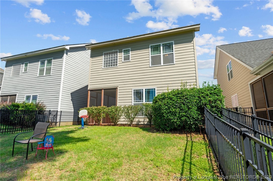 1365 Micahs Way North Spring Lake, NC 28390 - Photo 35 of 36 a front view of house with swing and slide