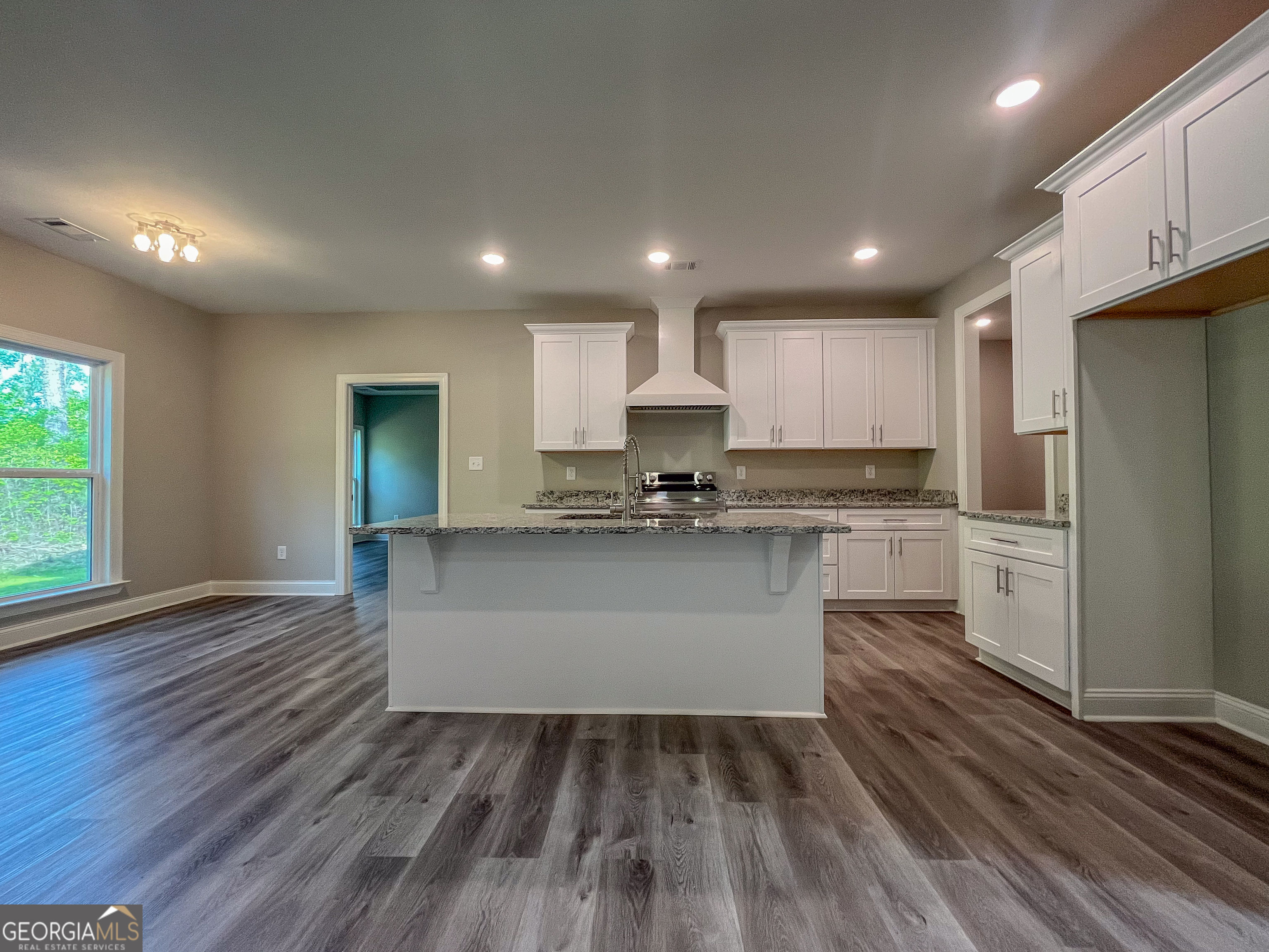 711 Flanders Lane Dublin, GA 31021 - Photo 7 of 49 a kitchen with granite countertop white cabinets and stainless steel appliances