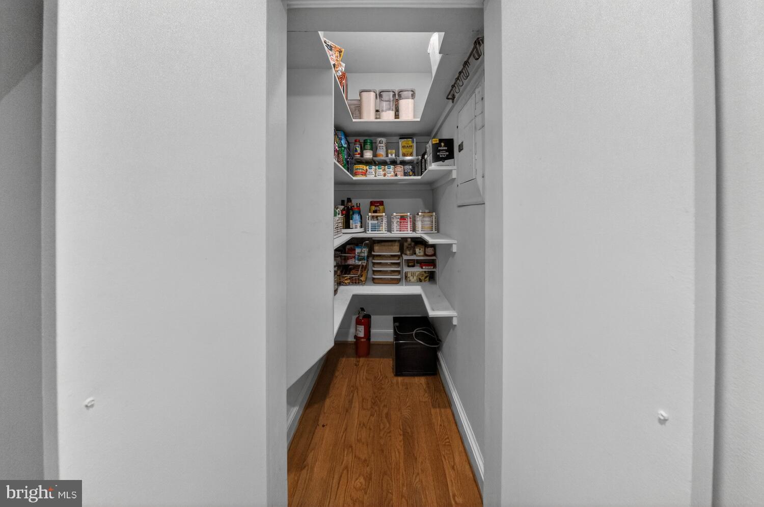 4529 38th Street Northwest Washington, DC 20016 - Photo 8 of 32 a view of a hallway with wooden floor and a white cabinet