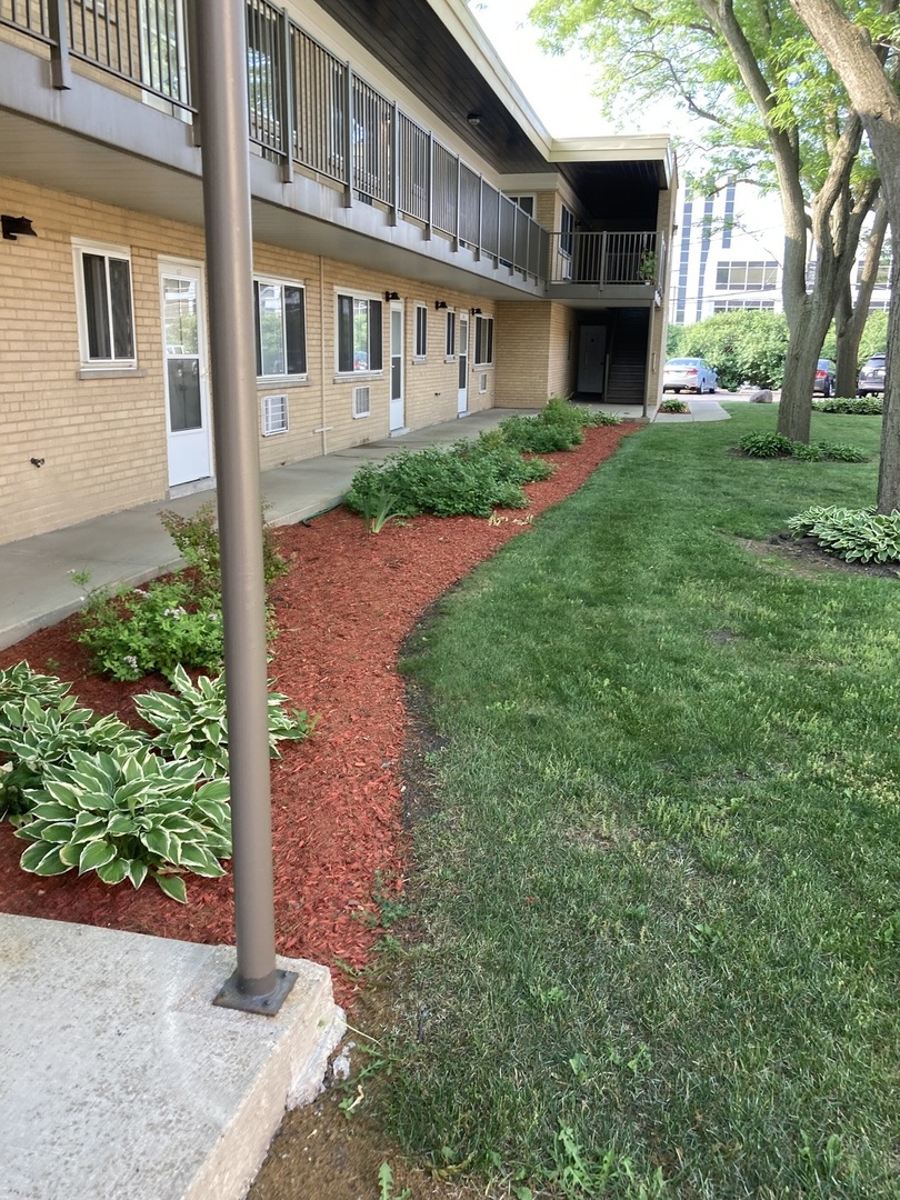 1017 Peterson Avenue, Unit A4 Park Ridge, IL 60068 - Photo 2 of 10 a front view of a house with garden