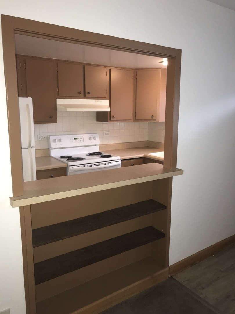 1017 Peterson Avenue, Unit A4 Park Ridge, IL 60068 - Photo 6 of 10 a view of kitchen with wooden floor and cabinets