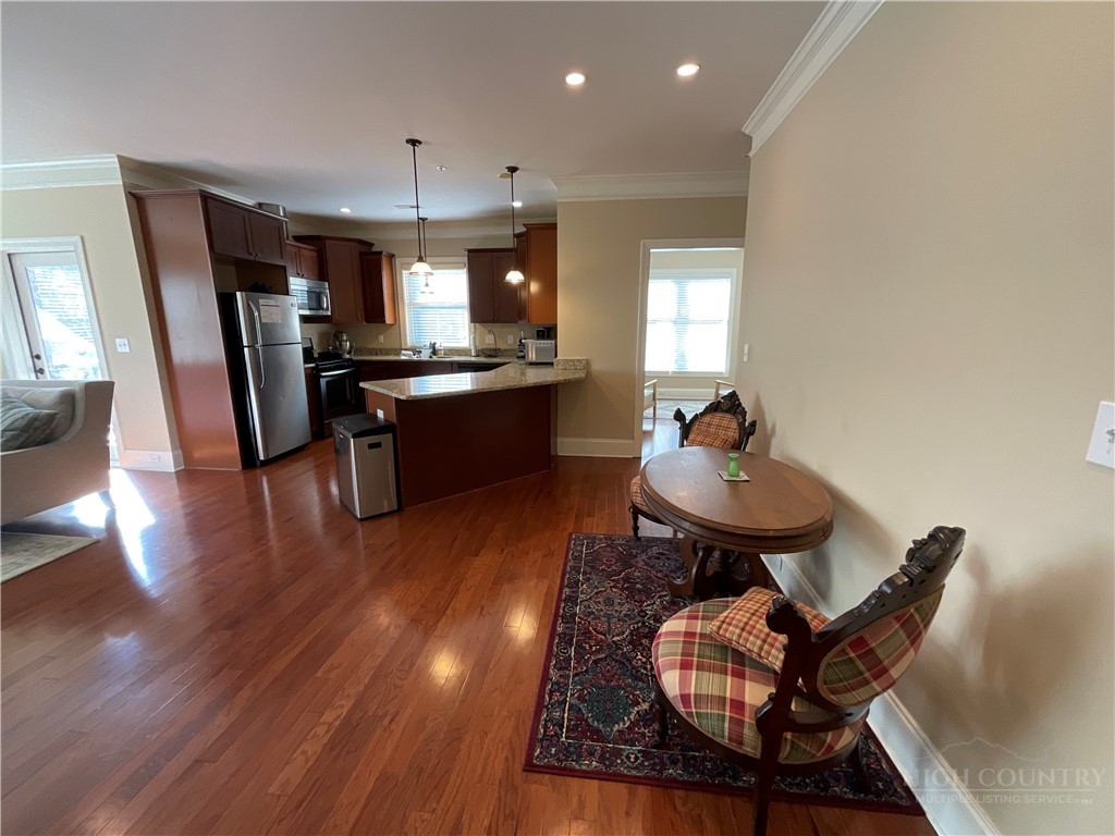 140 Gateway Drive, Unit 302 Boone, NC 28607 - Photo 13 of 30 a living room with dining room and wooden floor