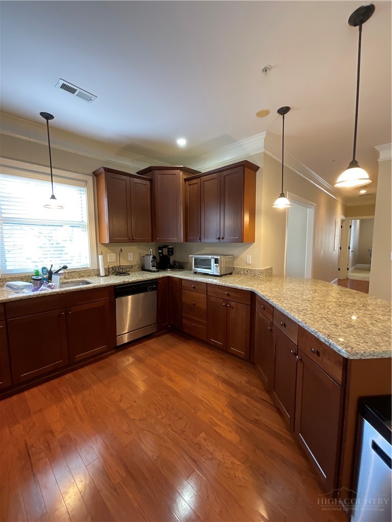 140 Gateway Drive, Unit 302 Boone, NC 28607 - Photo 19 of 30 a kitchen with stainless steel appliances granite countertop wooden cabinets a sink a stove a kitchen island and chairs