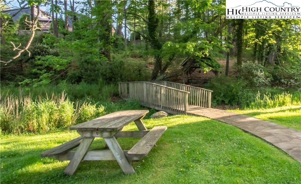 140 Gateway Drive, Unit 302 Boone, NC 28607 - Photo 9 of 30 a view of a swimming pool with a patio and a yard