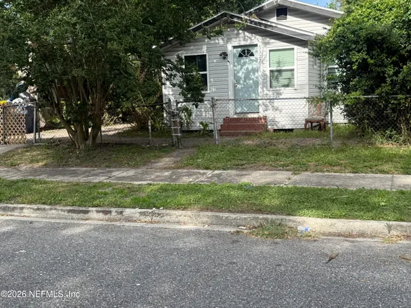 a view of backyard of house with green space