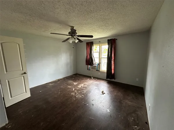 an empty room with windows and closet