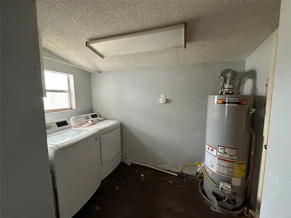 a room with water heater and a cabinet