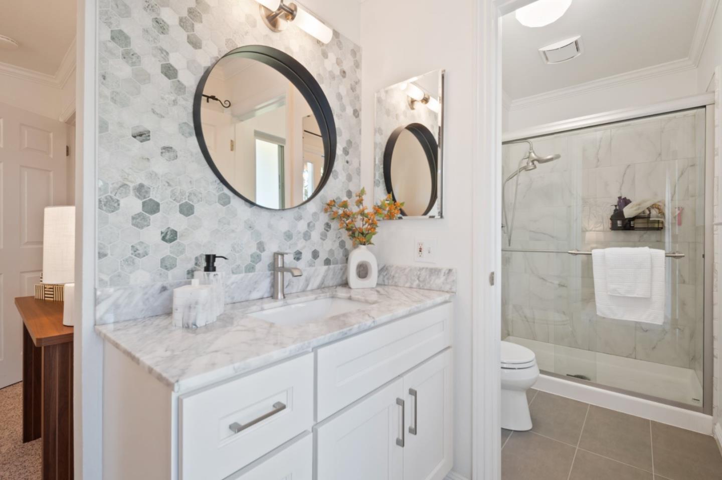 7453 Interlachen Avenue San Ramon, CA 94583 - Photo 18 of 35 a bathroom with a granite countertop sink a toilet and a shower