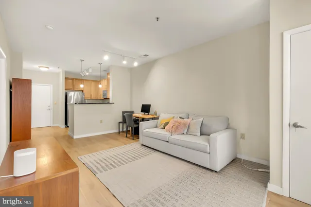 a living room with furniture and kitchen view