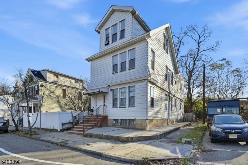 78 South Devine Street Newark, NJ 07106 - Photo 1 of 24 a front view of a building with lot of cars and trees