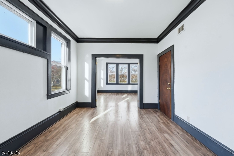 78 South Devine Street Newark, NJ 07106 - Photo 11 of 24 a view of livingroom with hardwood floor and hallway