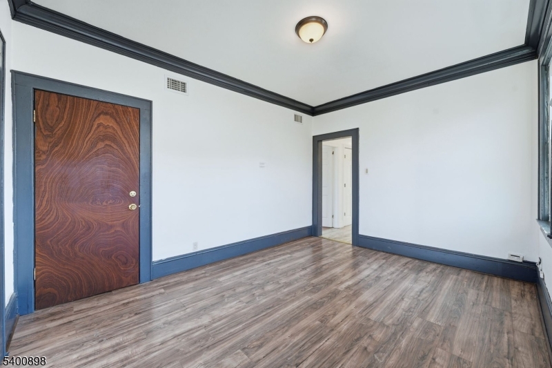 78 South Devine Street Newark, NJ 07106 - Photo 12 of 24 a view of an empty room with wooden floor and a window