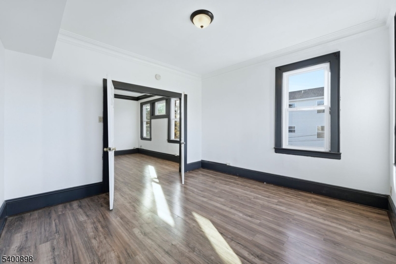 78 South Devine Street Newark, NJ 07106 - Photo 14 of 24 a view of a livingroom with wooden floor and window