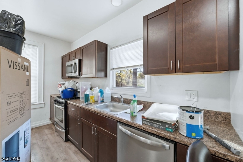 78 South Devine Street Newark, NJ 07106 - Photo 18 of 24 a kitchen with stainless steel appliances granite countertop a sink stove and refrigerator