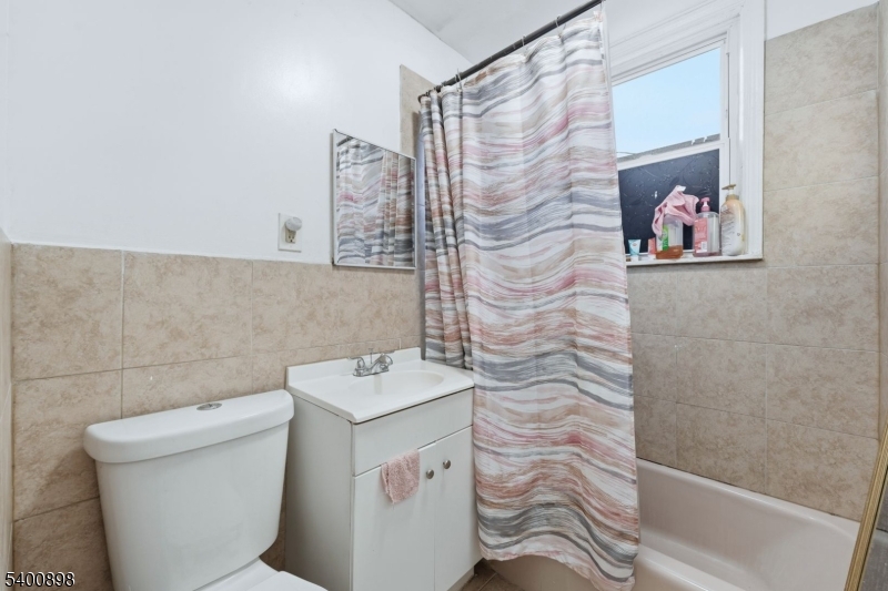 78 South Devine Street Newark, NJ 07106 - Photo 19 of 24 a bathroom with a shower and a toilet