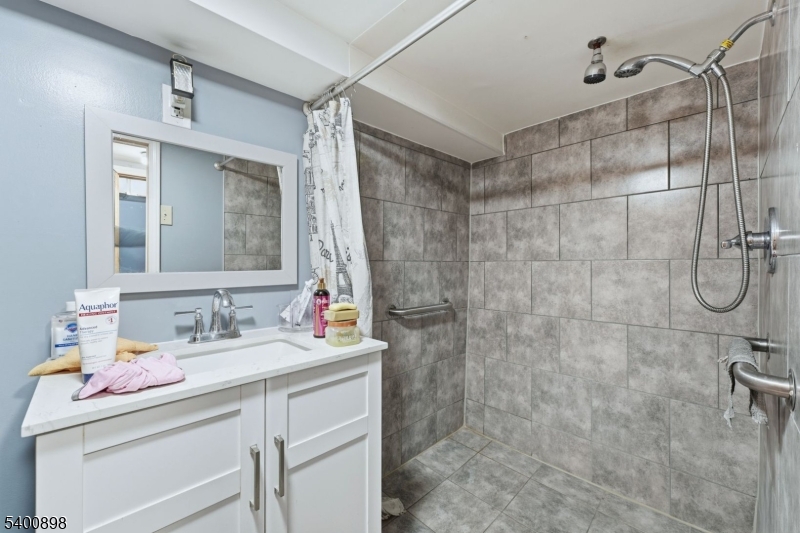 78 South Devine Street Newark, NJ 07106 - Photo 23 of 24 a bathroom with a sink vanity granite and shower