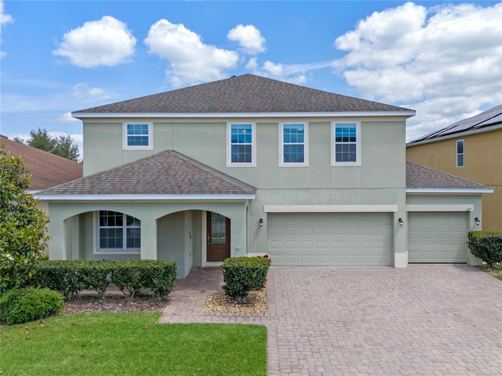 a front view of a house with a yard and garage
