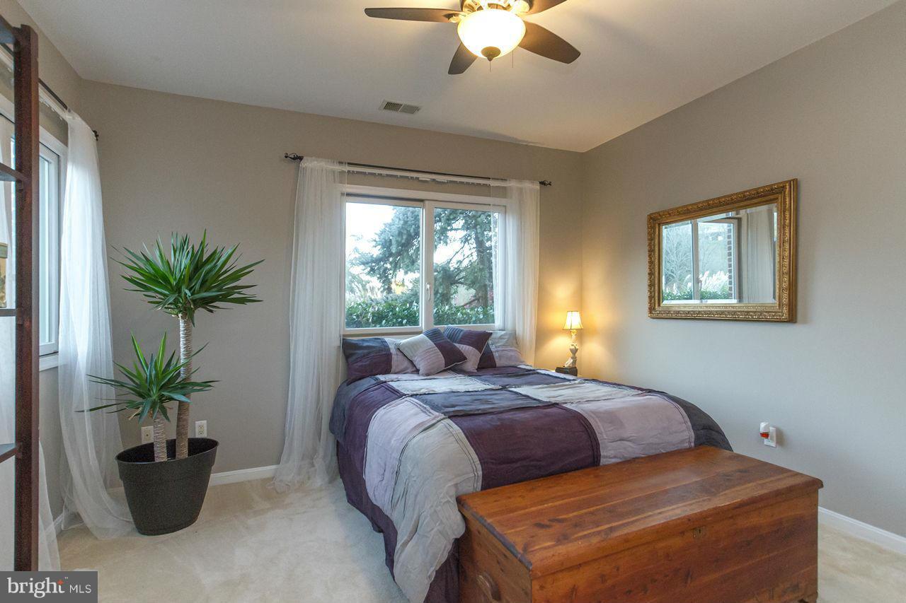 2223 Corbett Road Monkton, MD 21111 - Photo 21 of 30 a bedroom with a large bed and a potted plant