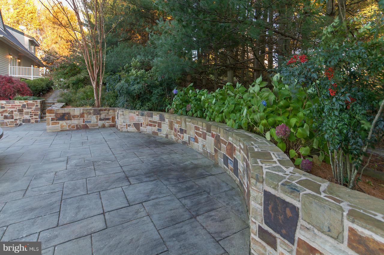 2223 Corbett Road Monkton, MD 21111 - Photo 27 of 30 a view of a yard with plants and a bench
