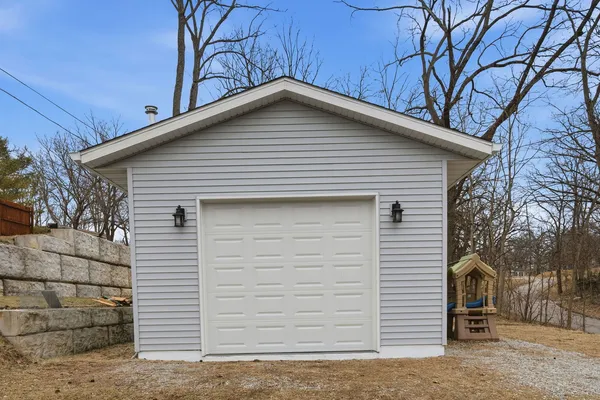 a view of a house with a yard and furniture