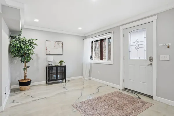 a living room with furniture and potted plant