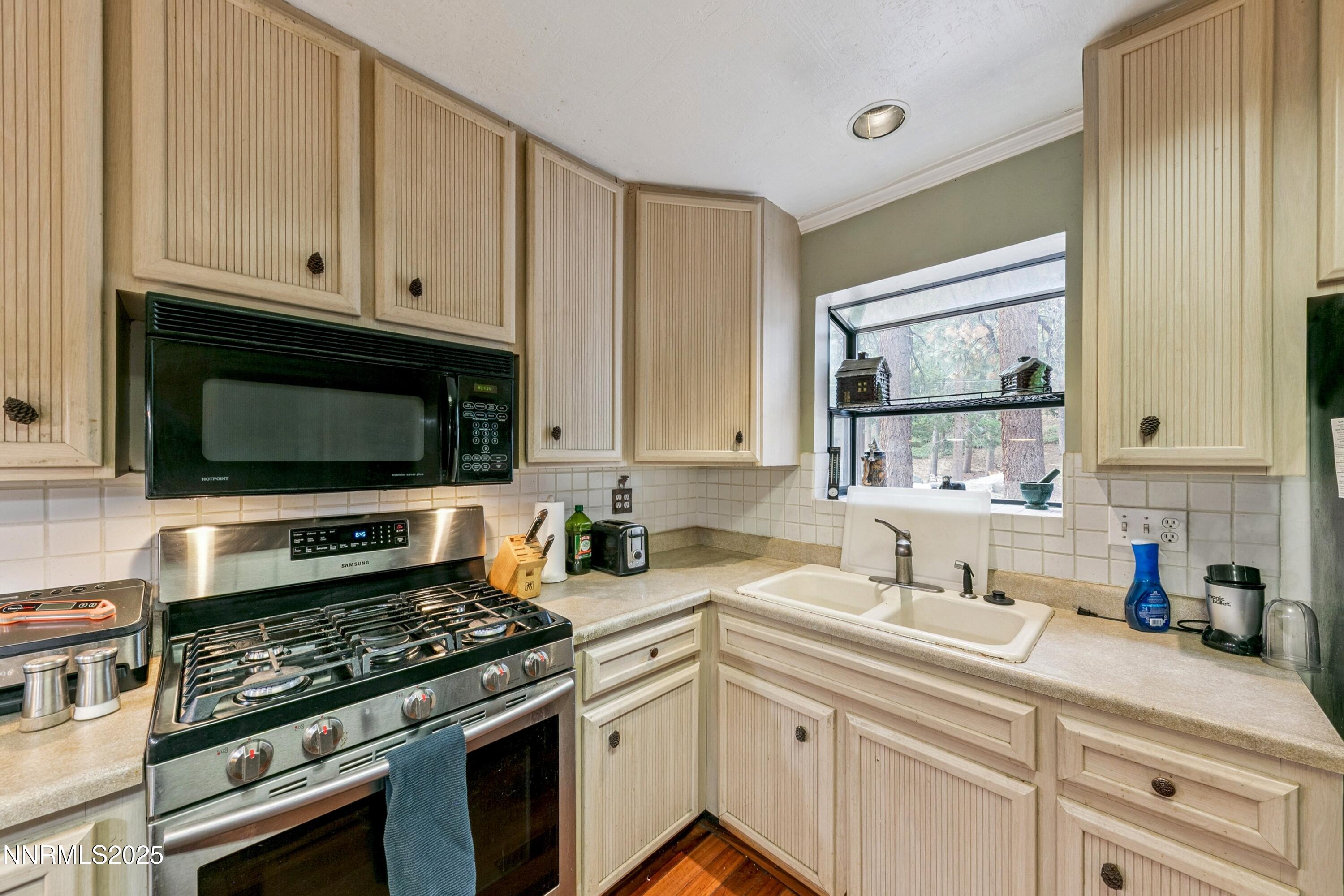134 Aspen Way Stateline, NV 89449 - Photo 11 of 25 a kitchen with white cabinets and appliances
