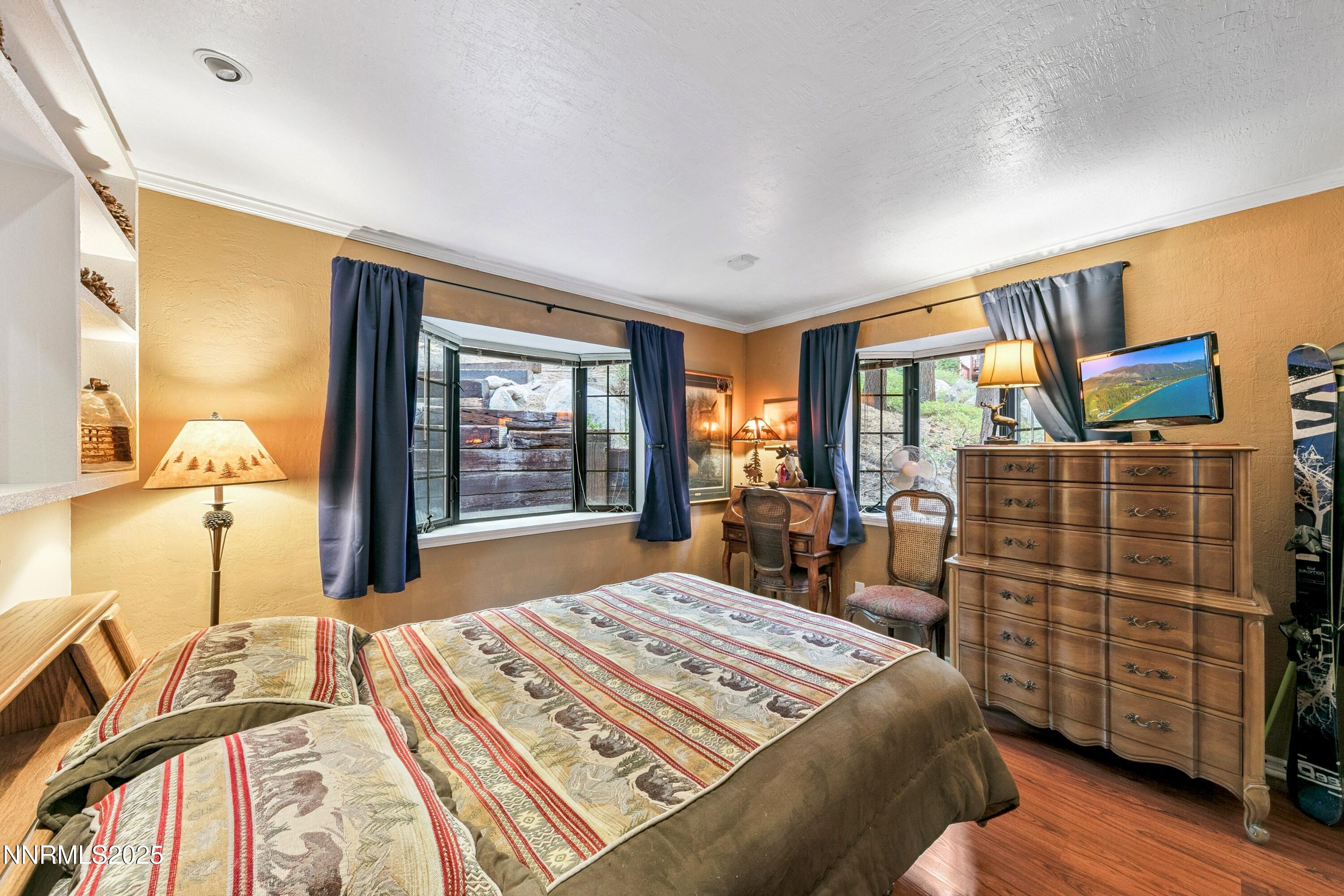 134 Aspen Way Stateline, NV 89449 - Photo 14 of 25 a bedroom with a bed and wooden floor