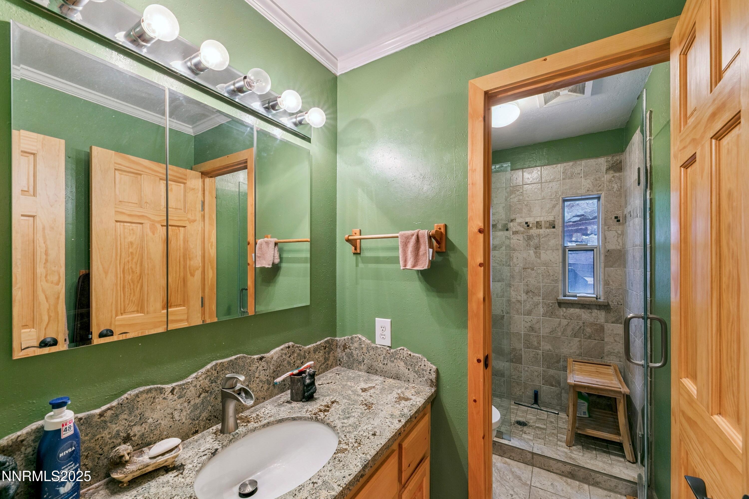 134 Aspen Way Stateline, NV 89449 - Photo 15 of 25 a bathroom with a granite countertop sink and a mirror