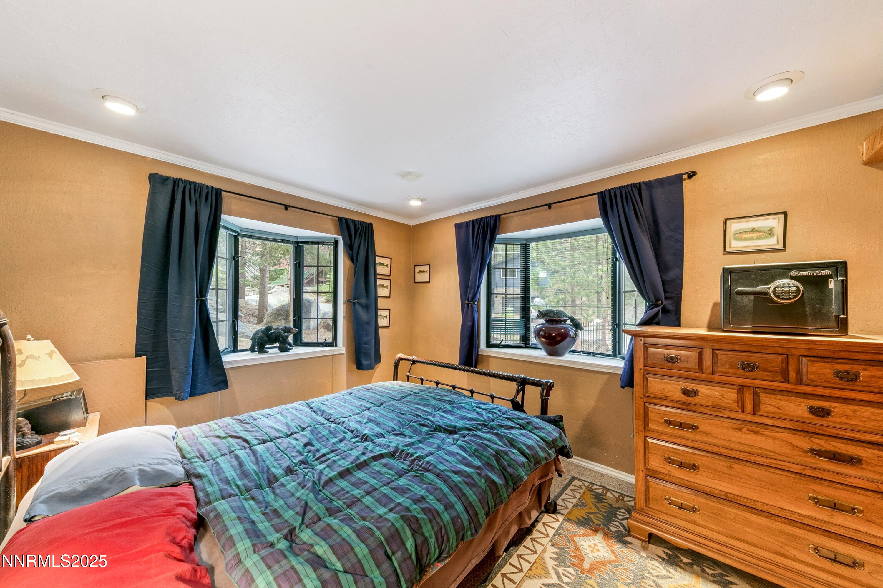 134 Aspen Way Stateline, NV 89449 - Photo 16 of 25 a bedroom with a bed and large windows