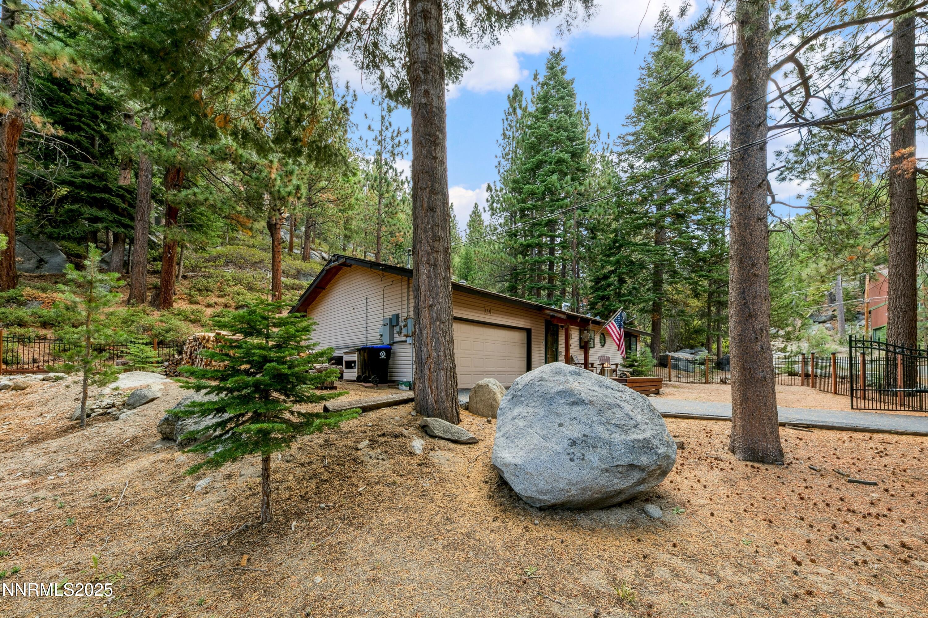134 Aspen Way Stateline, NV 89449 - Photo 19 of 25 a view of a backyard with a tree and plants