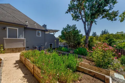 a view of house with yard and sitting area