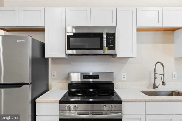 a kitchen with a sink cabinets and a window