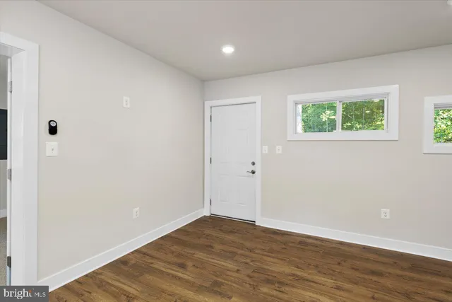 a view of a kitchen with stainless steel appliances a refrigerator and a stove top oven