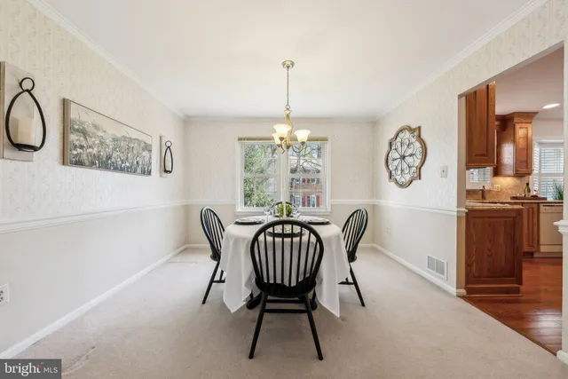 a dining room with furniture a chandelier and a rug